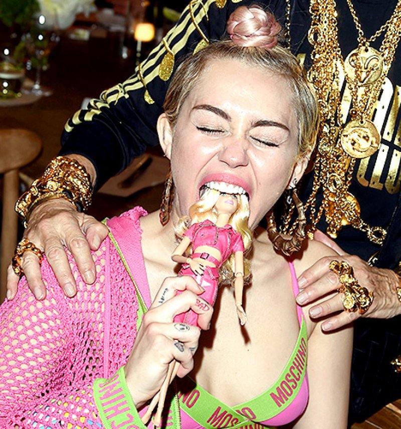 She Was Photographed Biting On A Barbie Doll-15 Images That Show Miley Cyrus Has Totally Lost It