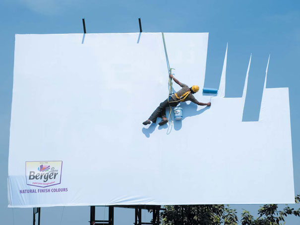 He is Painting Sky on a Billboard-15 Real Life Illusions That Are Sure To Amuse You