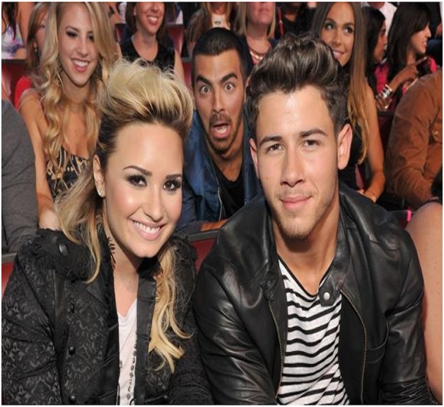 Joe Jonas Photobombs Demi Lovato & Nick Jonas-Top Hilarious Celebrity Photobombs