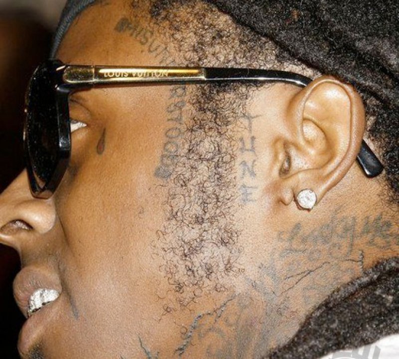 Lucky Me Under His Left Ear-15 Bizarre Lil Wayne's Tattoos And Their Meanings